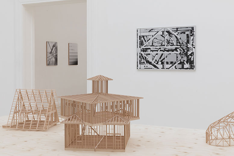 Building models made of wood and exhibited in a gallery