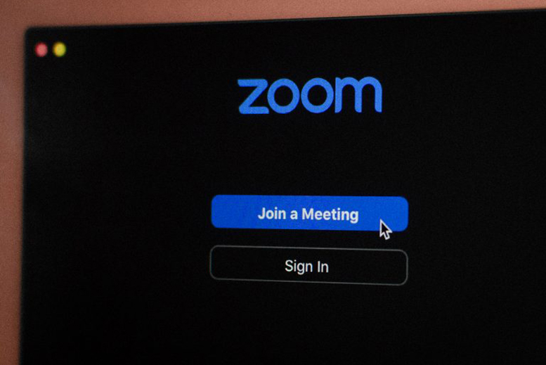 A Zoom screen with a cursor above the words 'Join a Meeting'